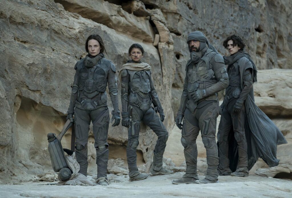 Rebecca Ferguson, Zendaya, Javier Bardem, and Timothée Chalamet, wearing stillsuits, in 'Dune: Part One'.