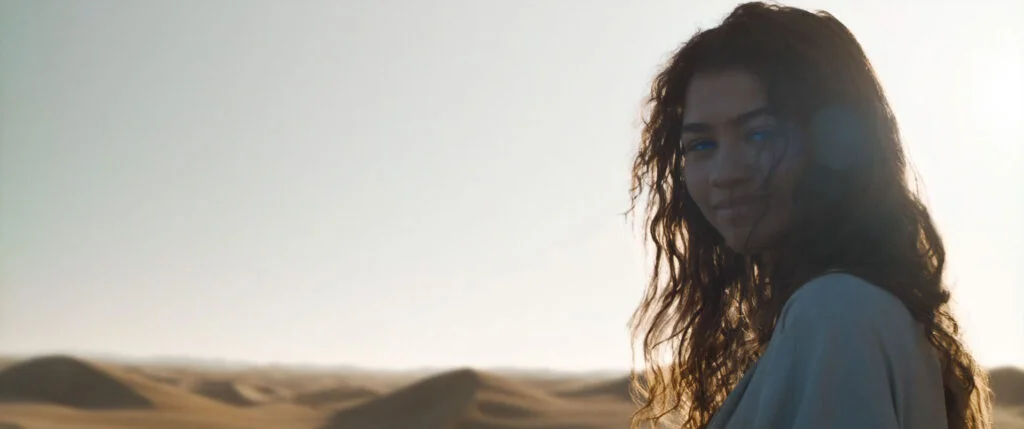 Chani (Zendaya) smiles joyfully in the deserts of Arrakis. Scene from second Dune movie trailer.