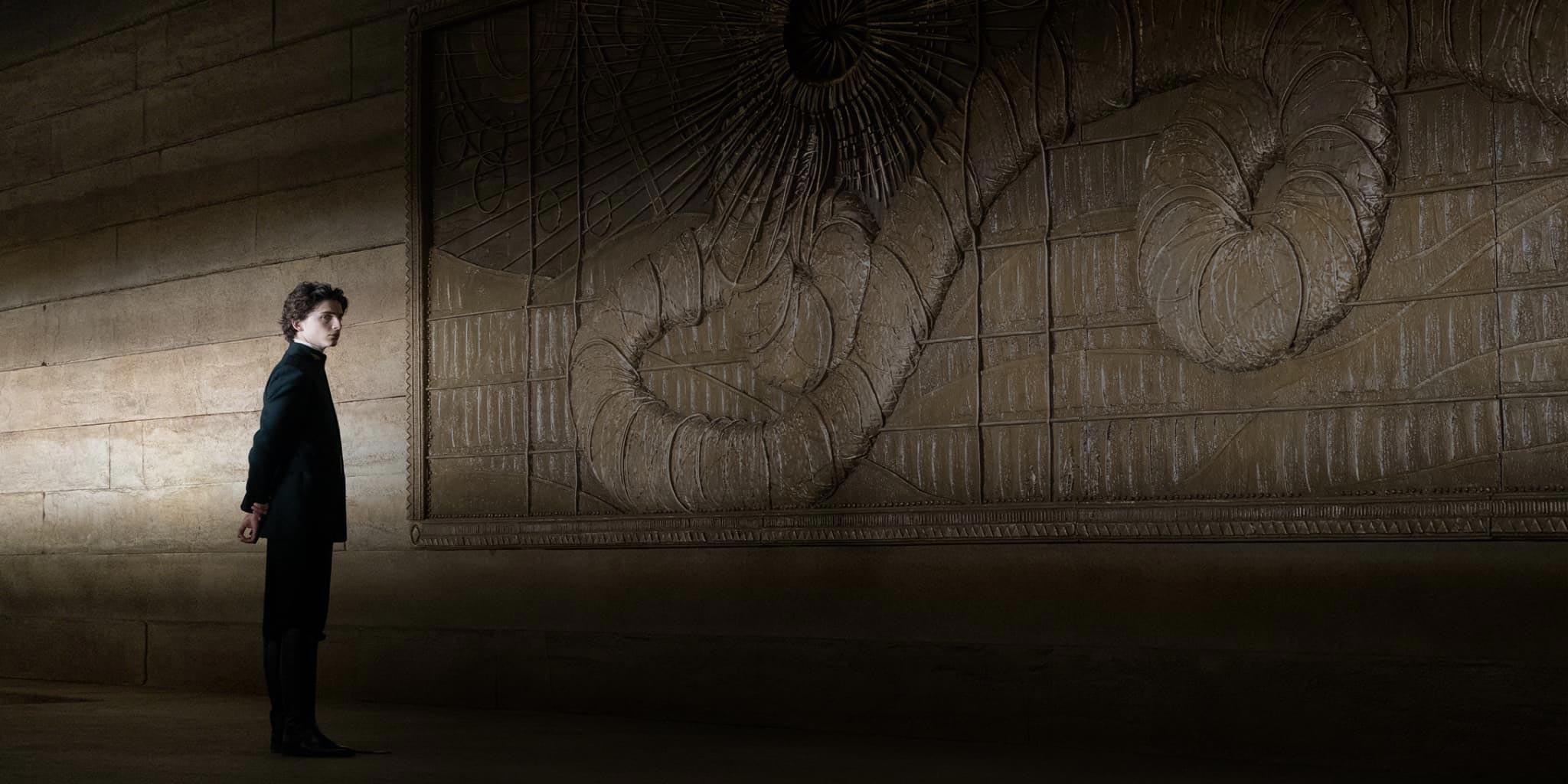 Paul Atreides looks at the mural of one of the native sandworms, inside the Governor's Residence of Arrakeen.