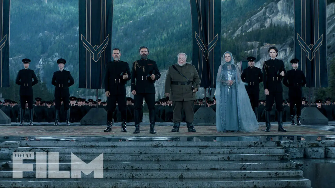 The House Atreides family, dressed in ceremonial attire, receive the Emperor's herald in one of the opening scenes of the Dune movie. 