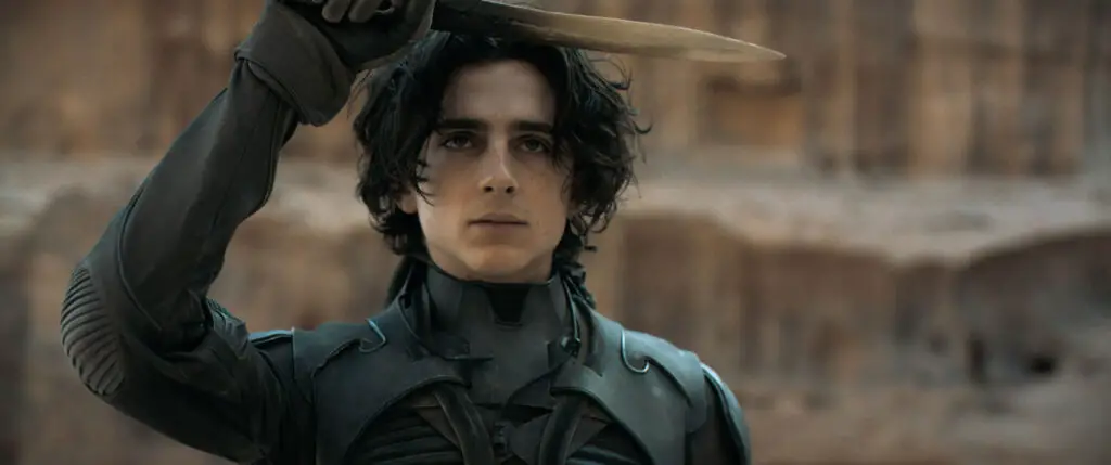 Paul Atreides, played by Timothée Chalamet, salutes with a crysknife in Denis Villeneuve's 'Dune: Part One' movie.