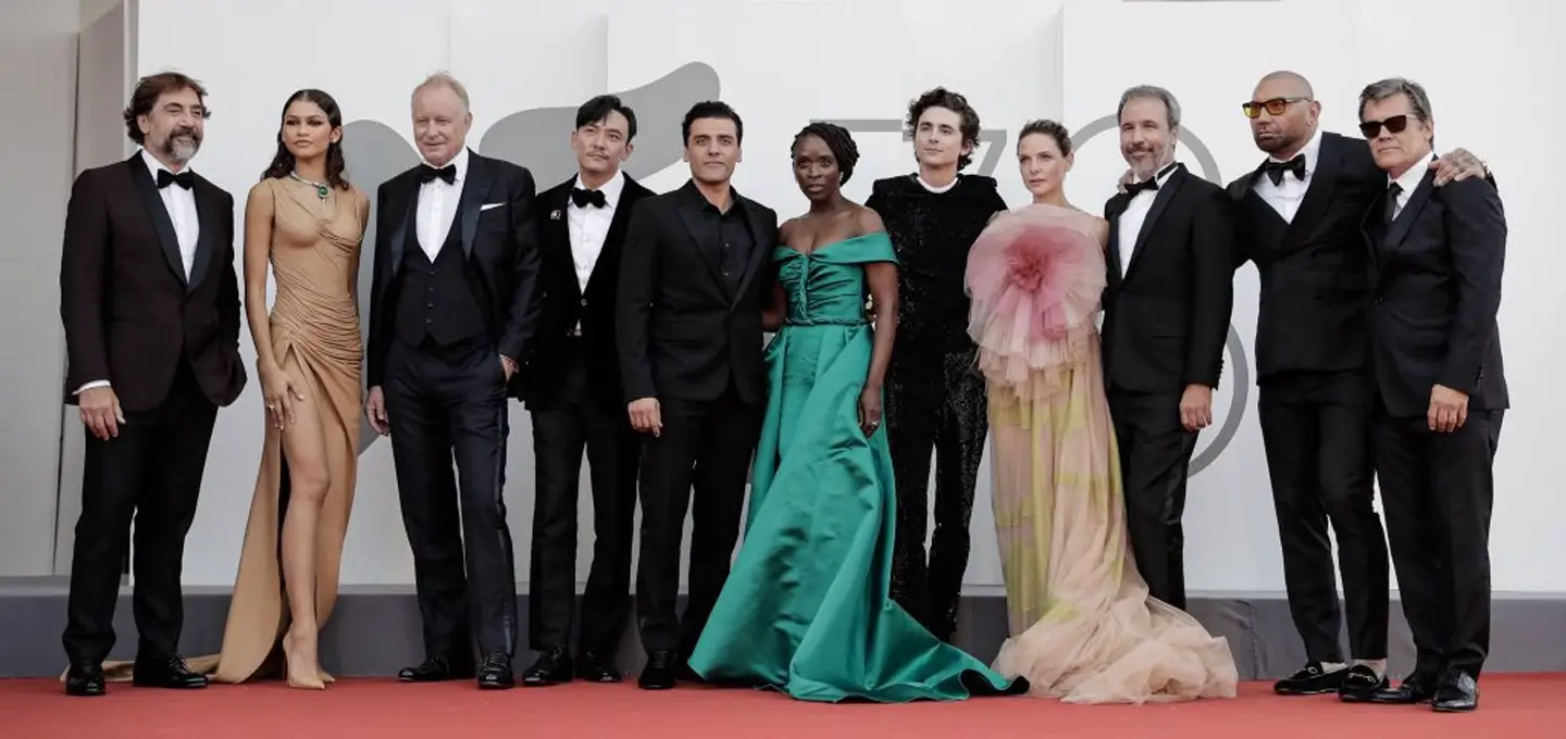 Group photo of Dune director Villeneuve and the movie's talented cast at the Venice Film Festival: Javier Bardem, Zendaya, Stellan Skarsgård, Chang Chen, Oscar Isaac, Sharon Duncan-Brewster, Timothée Chalamet, Rebecca Ferguson, Dave Bautista, and Josh Brolin.