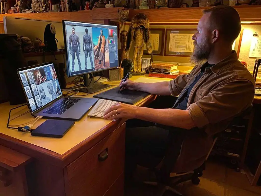 Staged photo featuring Keith Christensen working on concept art for Denis Villeneuve's Dune movie.