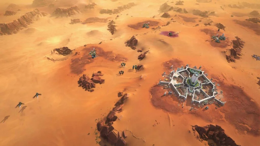 Daytime screenshot of Arrakeen, and surrounding activity, in 'Dune: Spice Wars', an upcoming real-time strategy game by Funcom and Shiro Games.