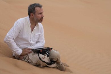 Denis Villeneuve sits in the sands of the Wadi Rum desert, in Jordan, during production of 'Dune'. The cast and crew are expected to return there to film part two.