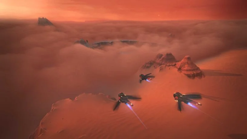 First gameplay trailer is released for 'Dune: Spice Wars', new strategy video game by Funcom and Shiro Games. Screenshot features ornithopters, flying over Arrakis during the sunset.