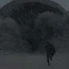 Paul Atreides runs from a gigantic sandworm in 2021's 'Dune' movie.