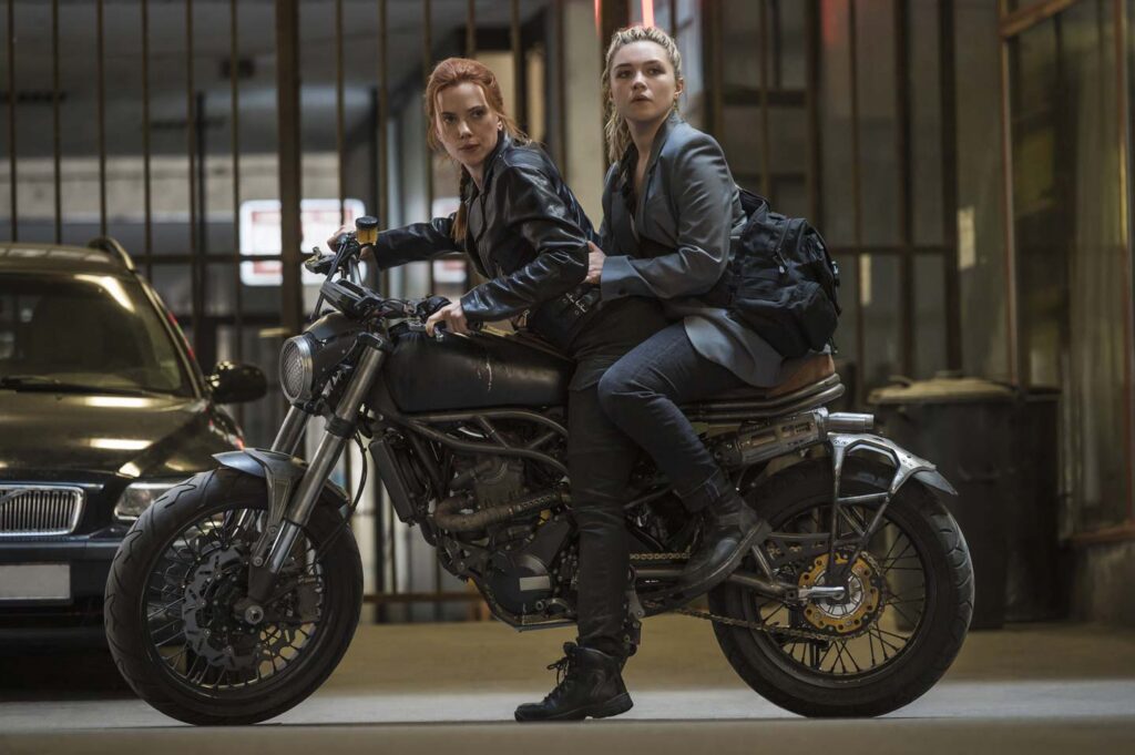 Photo of Scarlett Johansson and Florence Pugh on a motorcycle, in a scene from Marvels 'Black Widow' (2021).