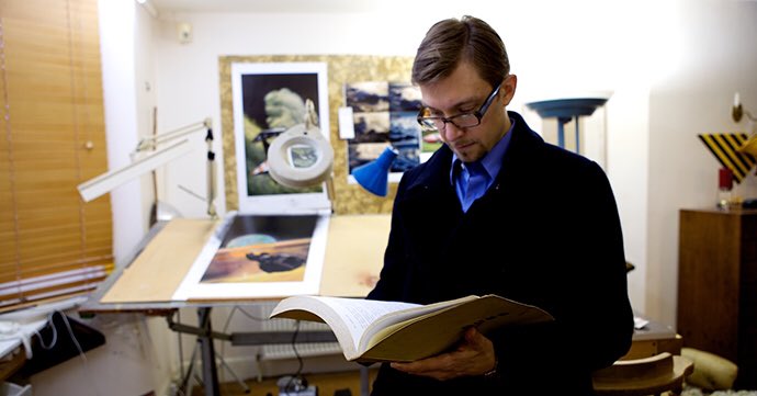 Photo of Frank Pavich, director of the 'Jodorowsky's Dune' documentary, reading the related 'Dune' script.