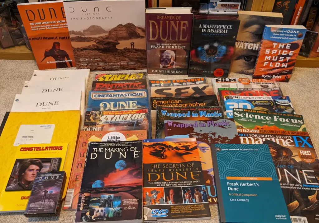 Photo showing dozens of publications that have covered 'Dune' and its movie adaptations, including 'The Making of Dune' by Ed Naha.