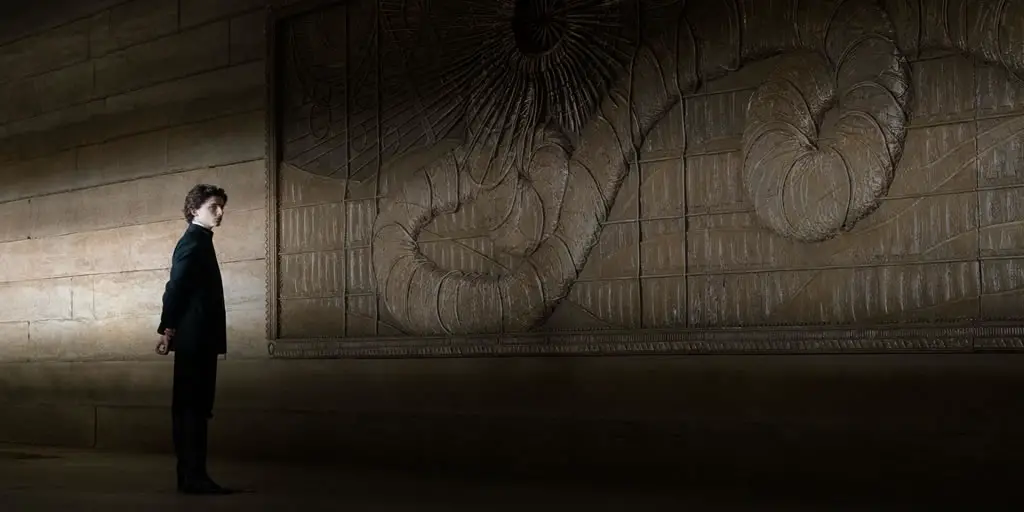 Paul Atreides (Timothée Chalamet) admires the Sandworm mural in Denis Villeneuve's 'Dune: Part One' movie (2021).