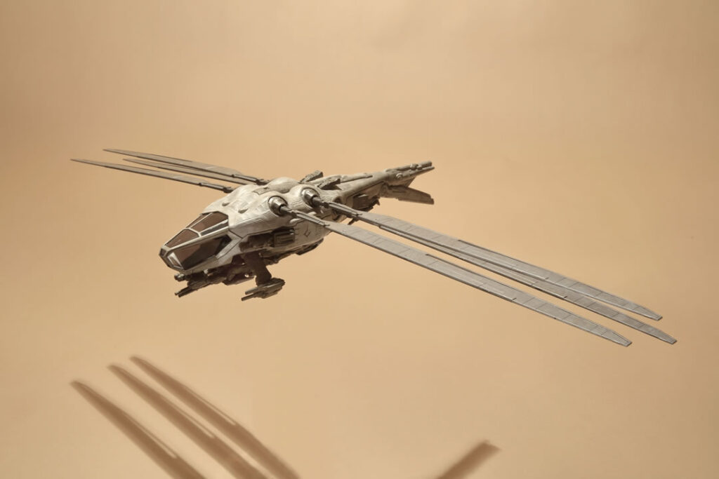 Photo of the 'Dune' Harkonnen Ornithopter Die-Cast Model in the air.