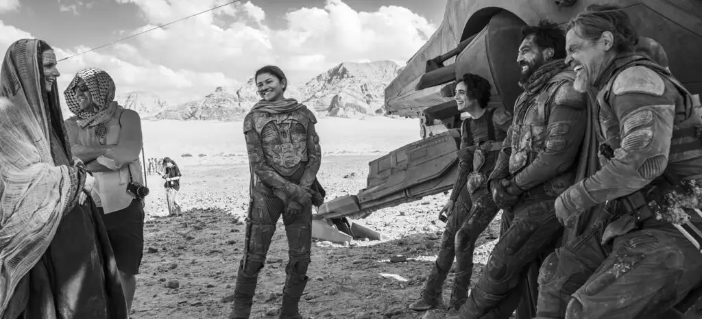 Behind-the-scenes group photo of the lead cast members in the 'Dune: Part Two' movie, including Rebecca Ferguson, Zendaya, Timothée Chalamet, Javier Bardem, and Josh Brolin.  