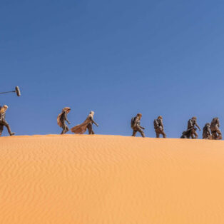 Preview from 'Dune Part Two: The Photography': Behind-the-scenes shot Fremen crossing the desert.
