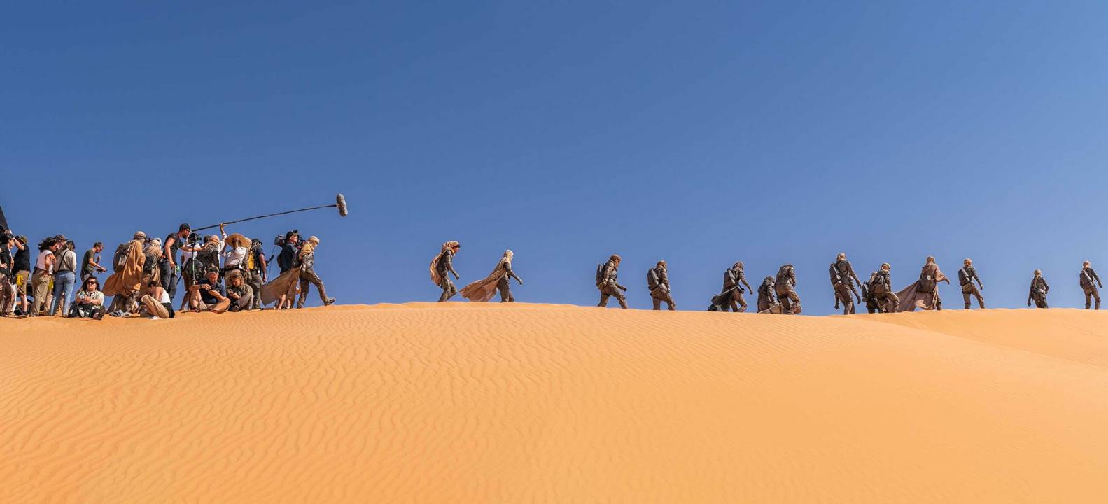 Preview from 'Dune Part Two: The Photography': Behind-the-scenes shot Fremen crossing the desert.